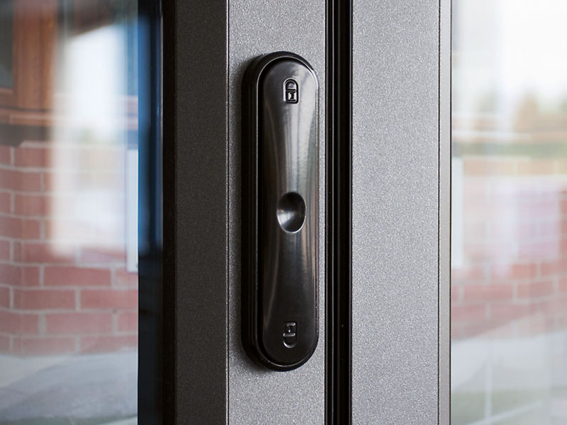 Flush pop-out handle detail on a modern bi-fold door panel