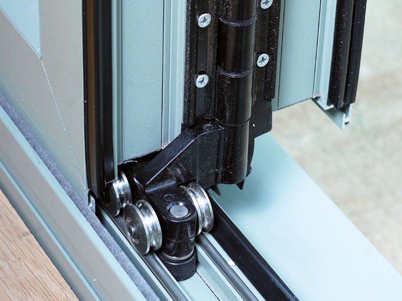 Close-up of bi-fold door roller hardware designed for smooth movement