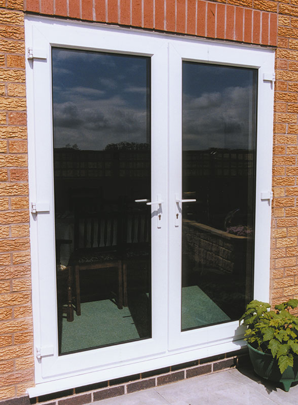 White flush-style French doors on a residential extension