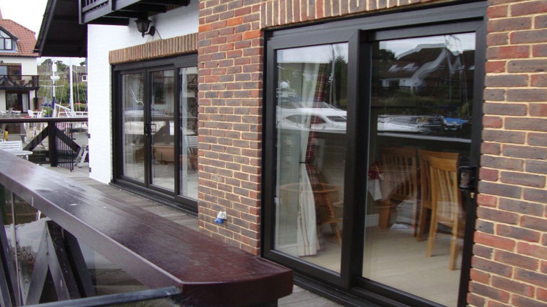 Dual patio door opening with black frames and large glass areas