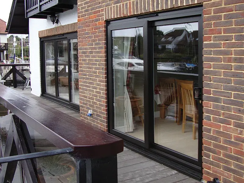 Large aluminium sliding door set on a contemporary riverside home