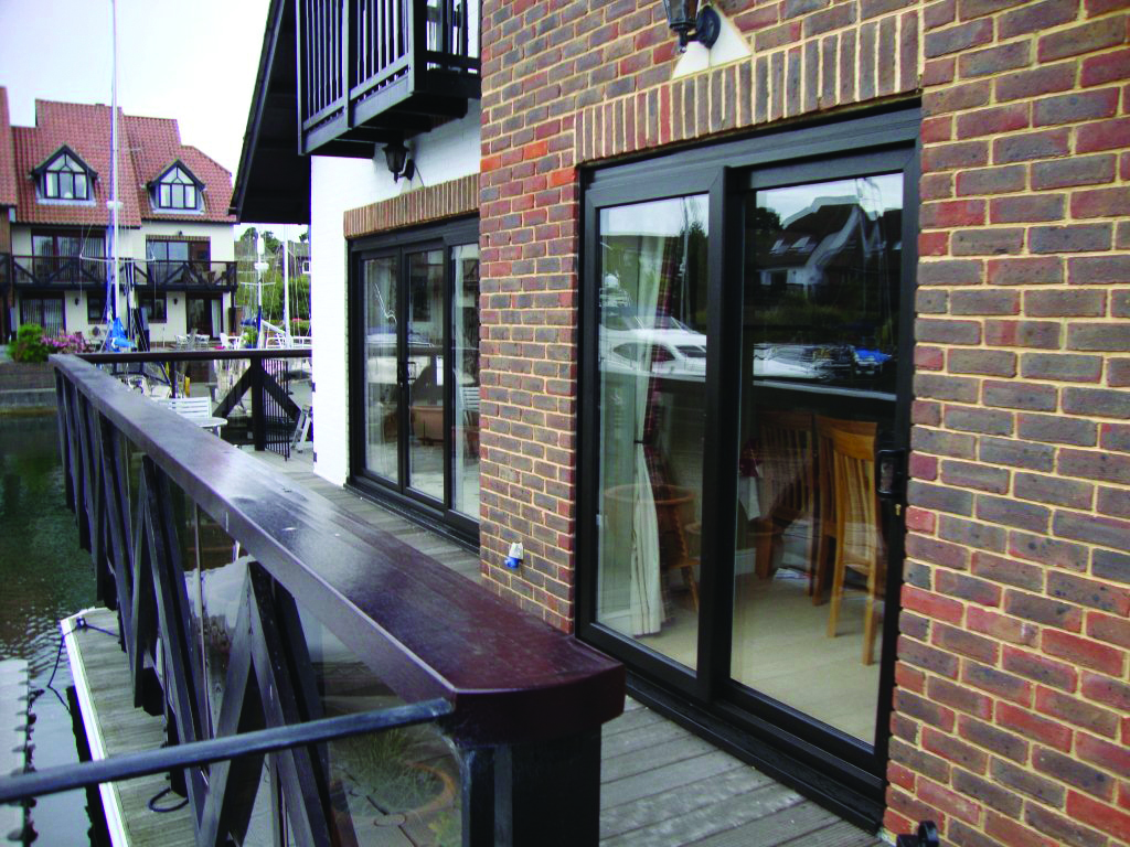 Black aluminium sliding door viewed from a modern interior