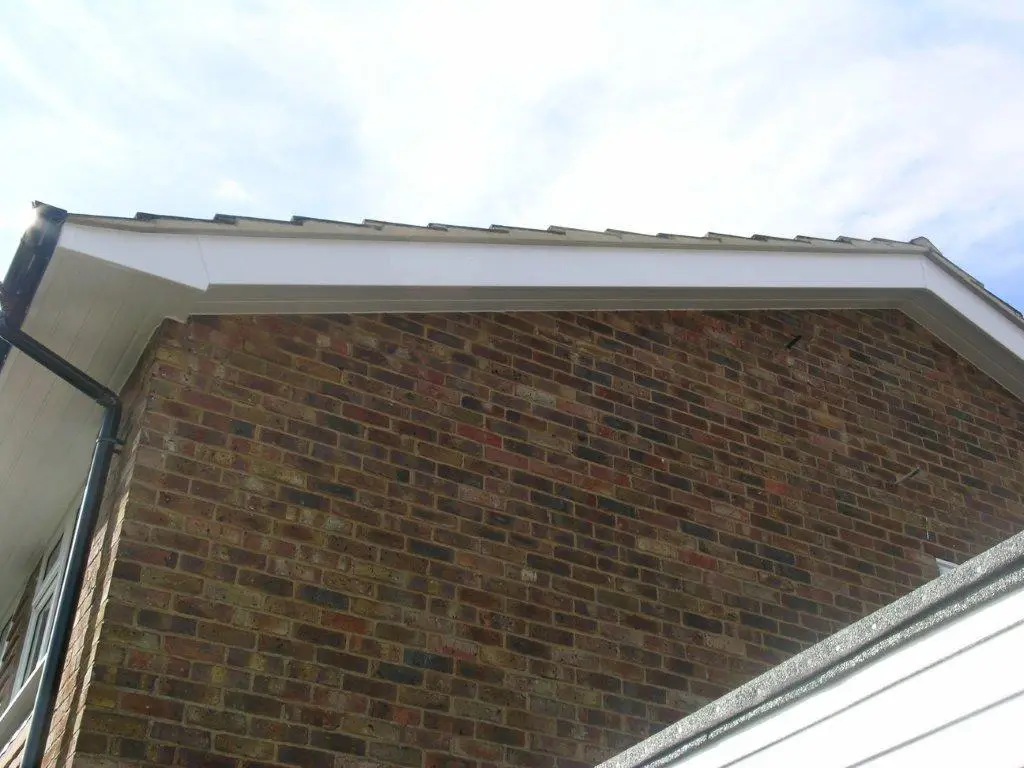 New roofline installation with soffit vents and downpipe alignment