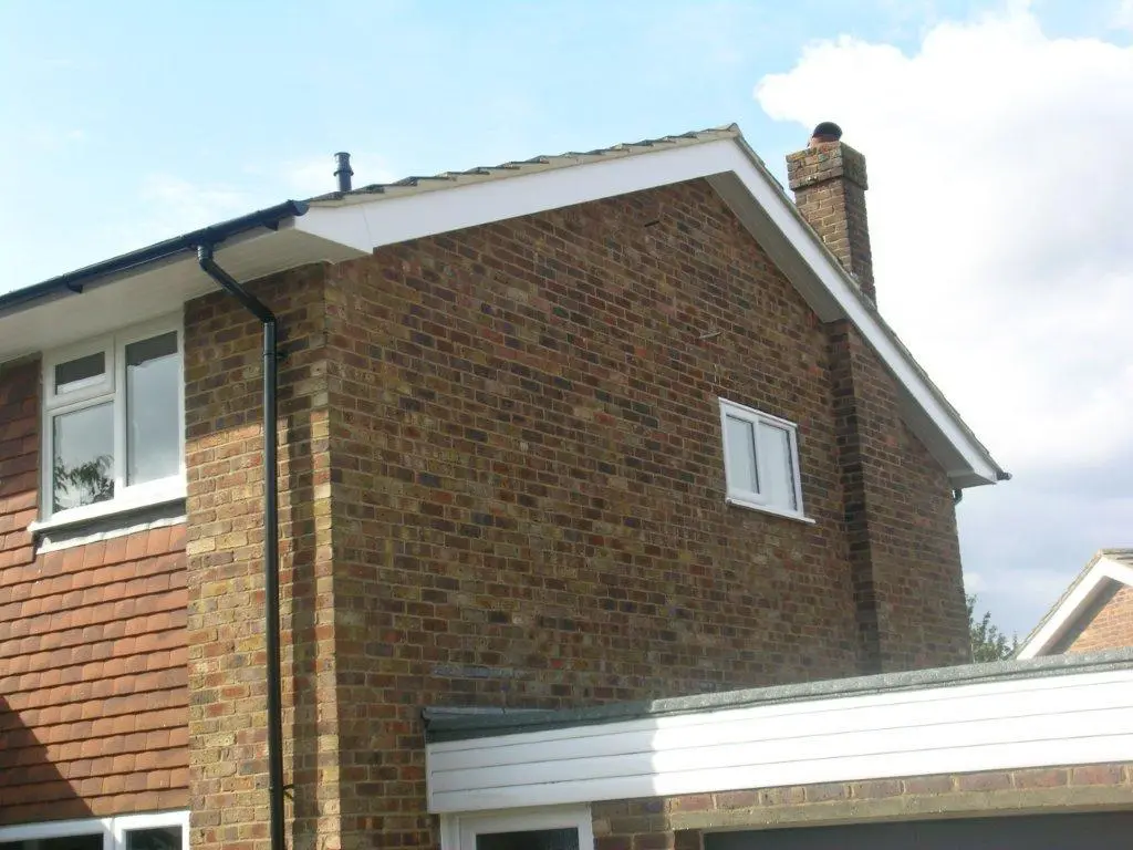 Full roofline run with white fascia and black rainwater goods