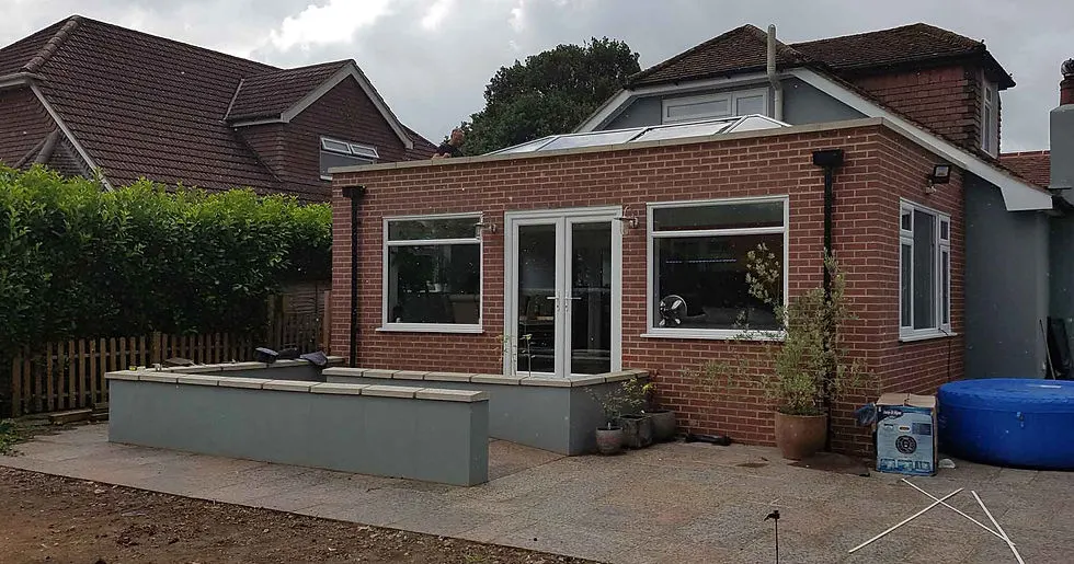 Rear home extension with clean roofline and black guttering installed by Homebrite
