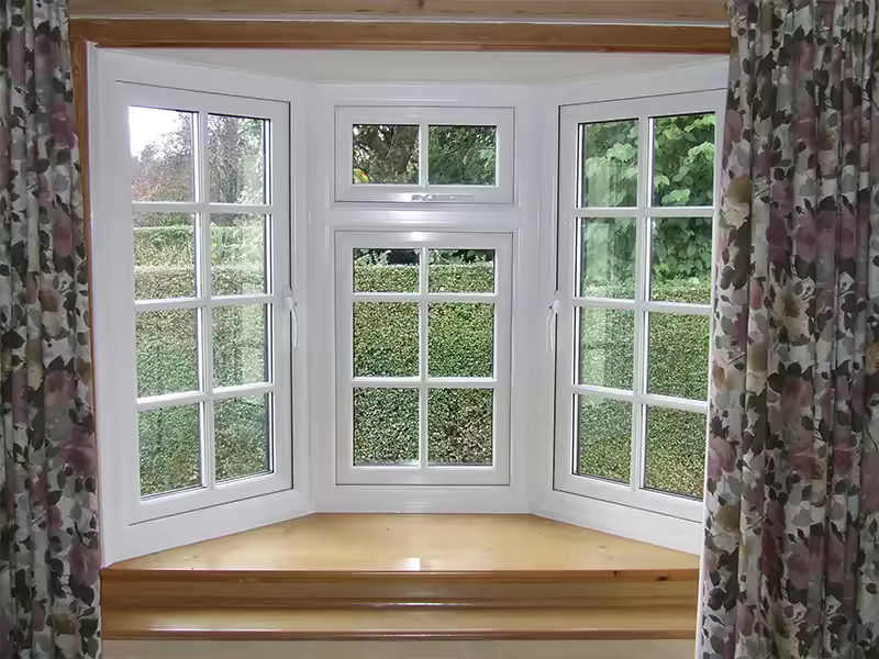 Interior view through a white uPVC bow window with multiple glazed sections
