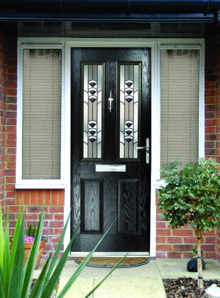Blue composite-style door with decorative glazed sections