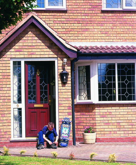 Traditional style front entrance with classic panel design and decorative glazing