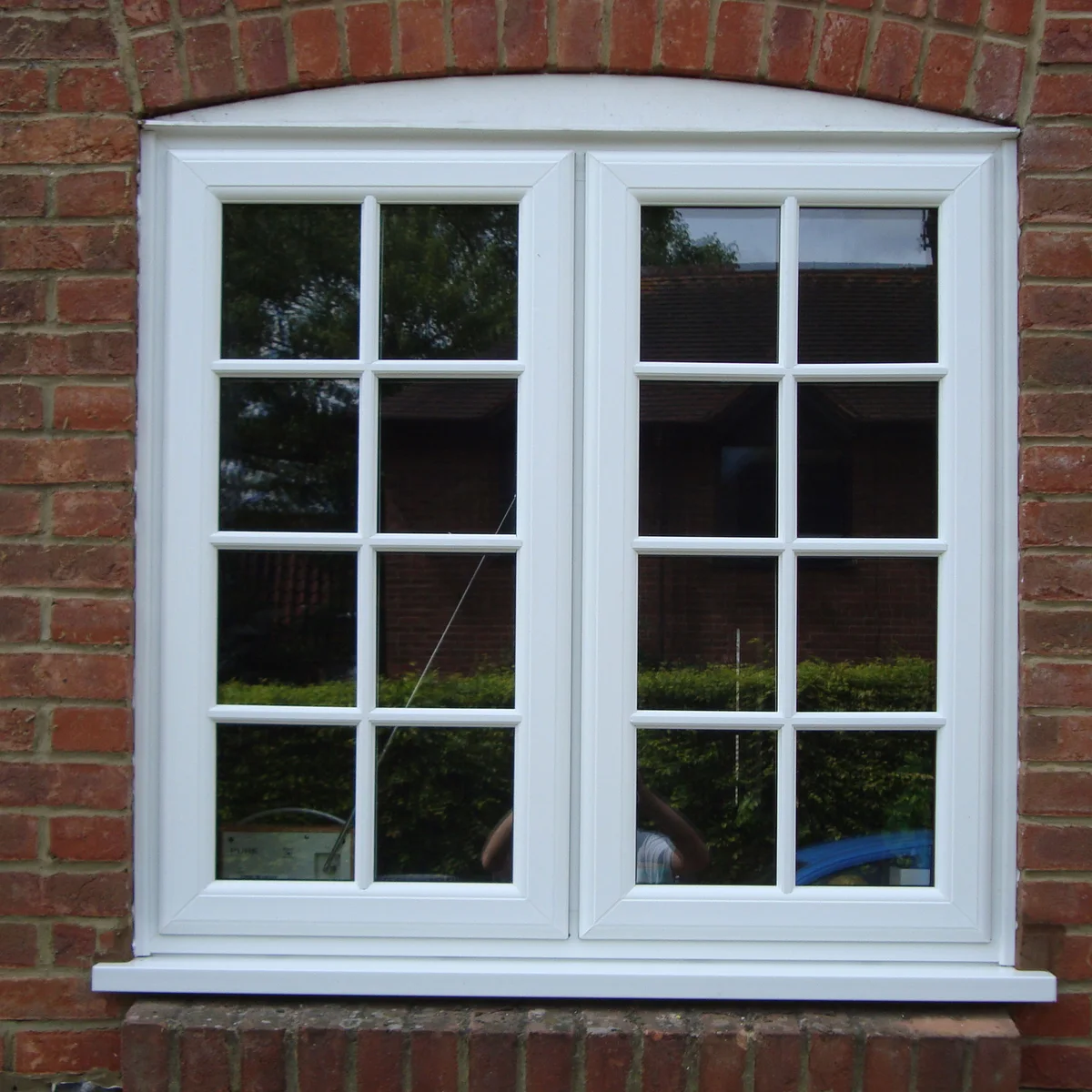 White casement window installation with slim glazing bars