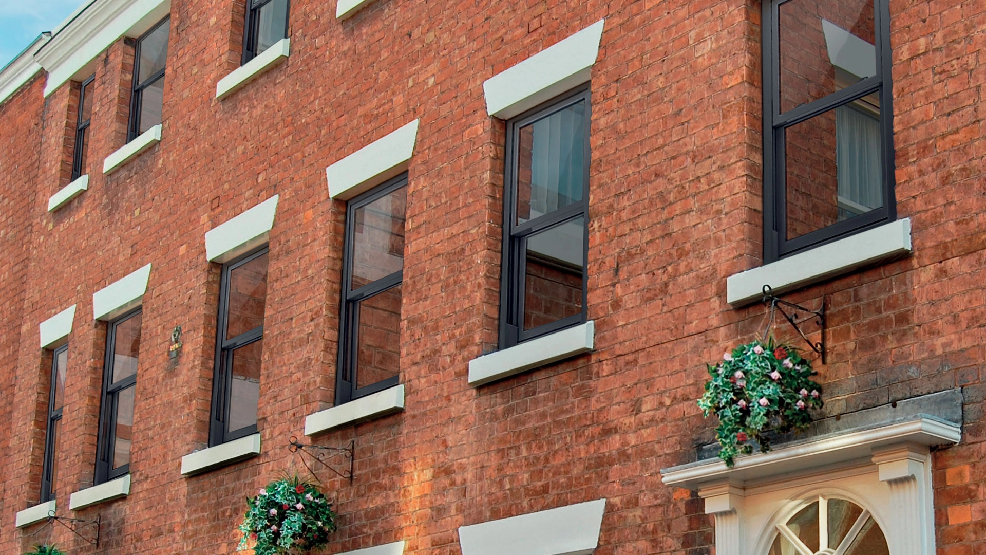 Multi-storey home with vertical sliding window installations